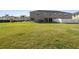 Grassy backyard space offering ample outdoor enjoyment with a lovely home view at 5022 Chipotle Ln, Wesley Chapel, FL 33544