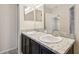 Well-lit bathroom featuring a double sink vanity with granite countertop and a shower with glass door at 5022 Chipotle Ln, Wesley Chapel, FL 33544