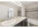 Bathroom with double sink vanity and a tub with decorative tile surround at 5022 Chipotle Ln, Wesley Chapel, FL 33544