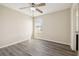 Bedroom featuring wood-look floors, a ceiling fan, and a bright window at 5022 Chipotle Ln, Wesley Chapel, FL 33544