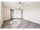Bedroom with wood-look floors, closet, ceiling fan and a large window with light coming in at 5022 Chipotle Ln, Wesley Chapel, FL 33544