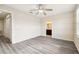 This bright bedroom features stylish gray flooring and a ceiling fan for added comfort at 5022 Chipotle Ln, Wesley Chapel, FL 33544