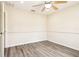 Neutral bedroom features modern wood-look flooring, a fan and ample natural light, with access to an adjacent room at 5022 Chipotle Ln, Wesley Chapel, FL 33544