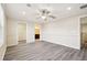Large bedroom with an ensuite bathroom, ceiling fan, and wood-look floors at 5022 Chipotle Ln, Wesley Chapel, FL 33544