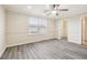 Spacious bedroom with wood-look floors, ceiling fan, and natural light at 5022 Chipotle Ln, Wesley Chapel, FL 33544