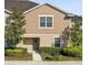 Inviting home exterior with manicured landscaping, a well-maintained lawn, and a charming townhome facade at 5022 Chipotle Ln, Wesley Chapel, FL 33544
