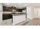 Kitchen featuring granite countertops, dark wood cabinetry, stainless steel appliances, and an island at 5022 Chipotle Ln, Wesley Chapel, FL 33544