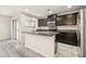 Kitchen area featuring dark wood cabinets, granite countertops, and stainless steel appliances at 5022 Chipotle Ln, Wesley Chapel, FL 33544