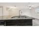 A kitchen island sink with granite countertops and neutral paint, inside an open concept layout at 5022 Chipotle Ln, Wesley Chapel, FL 33544