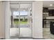 A shot out of the kitchen through sliding glass doors and into a lanai with backyard views at 5022 Chipotle Ln, Wesley Chapel, FL 33544