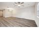 Spacious living room with a ceiling fan, wood-look flooring, and decorative wall trim at 5022 Chipotle Ln, Wesley Chapel, FL 33544