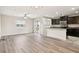 Open-concept living space featuring wood-look floors and lots of natural light at 5022 Chipotle Ln, Wesley Chapel, FL 33544