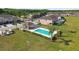 Aerial shot of a community pool with surrounding greenery and lounge area at 5022 Chipotle Ln, Wesley Chapel, FL 33544