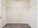 Walk-in closet with shelving and wood-look floors at 5022 Chipotle Ln, Wesley Chapel, FL 33544