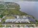 Beautiful aerial view of a bayfront property with a community pool, tennis court and boat dock at 515 Leffingwell Ave # 211, Ellenton, FL 34222