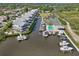 Aerial view of waterfront condos, a pool, a tennis court and boat docks at 515 Leffingwell Ave # 211, Ellenton, FL 34222