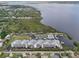 Stunning aerial view of waterfront condos with boat docks, pool, tennis court, and lush landscaping at 515 Leffingwell Ave # 211, Ellenton, FL 34222