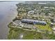 A wider aerial view of waterfront condos with boat docks, pool and tennis court in the background at 515 Leffingwell Ave # 211, Ellenton, FL 34222