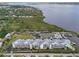 Aerial view of a waterfront condo complex with docks, tennis courts, and a pool at 515 Leffingwell Ave # 211, Ellenton, FL 34222