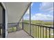 Balcony with green views and a black metal railing with white trim at 515 Leffingwell Ave # 211, Ellenton, FL 34222