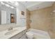 Cozy bathroom featuring tiled walls, neutral-toned sink, bathtub, and shower combination at 515 Leffingwell Ave # 211, Ellenton, FL 34222