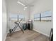 Bedroom featuring wood-look flooring, high ceilings, and lots of natural light from dual windows at 515 Leffingwell Ave # 211, Ellenton, FL 34222