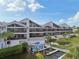 Exterior view of a multi-story condo complex with private balconies and boat docks at 515 Leffingwell Ave # 211, Ellenton, FL 34222