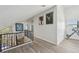 Hallway featuring wood-look flooring, white walls, high ceilings, and black iron railing at 515 Leffingwell Ave # 211, Ellenton, FL 34222