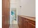 Hallway featuring built-in wood cabinets that lead to a bathroom with a bathtub and shower at 515 Leffingwell Ave # 211, Ellenton, FL 34222