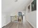 Upstairs hallway features wood-look floors, white walls, high ceilings, and black iron railing at 515 Leffingwell Ave # 211, Ellenton, FL 34222