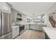 Open concept kitchen with stainless appliances and gray cabinets at 515 Leffingwell Ave # 211, Ellenton, FL 34222