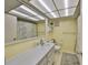 Bright bathroom featuring a large mirror, vanity, and tiled floor, offering a clean and functional space at 5155 9Th N Ave # 102, St Petersburg, FL 33710