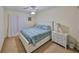 Cozy bedroom with a white bed frame, patterned bedding, side tables, and a ceiling fan at 5155 9Th N Ave # 102, St Petersburg, FL 33710