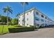 Exterior full view of multi-level building with mature landscaping and palm trees at 5155 9Th N Ave # 102, St Petersburg, FL 33710