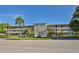 Exterior full view of multi-level building with mature landscaping and palm trees at 5155 9Th N Ave # 102, St Petersburg, FL 33710