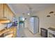 Bright kitchen featuring wood cabinets, granite countertops, and modern appliances, leading into the living space at 5155 9Th N Ave # 102, St Petersburg, FL 33710