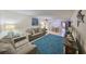 Inviting living room with neutral paint, a large plush rug, and comfortable seating for a cozy atmosphere at 5155 9Th N Ave # 102, St Petersburg, FL 33710