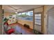 Bright sunroom with a sofa, rattan chairs, and large windows offering a pleasant view of the outdoors at 5155 9Th N Ave # 102, St Petersburg, FL 33710
