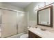 Clean bathroom featuring a shower with sliding glass door, a toilet, and a wooden vanity at 5246 81 N St # 24, St Petersburg, FL 33709