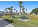 Community picnic area provides a relaxing outdoor space with lush landscaping and shade from palm trees at 5246 81 N St # 24, St Petersburg, FL 33709
