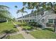 Well-maintained condo building with lush landscaping, sidewalk and staircase at 5246 81 N St # 24, St Petersburg, FL 33709
