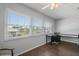 Bright, airy office space featuring laminate wood floors, large windows, and built-in desk at 5246 81 N St # 24, St Petersburg, FL 33709