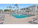 Community pool with lounge chairs and a thatched-roof tiki hut at 5246 81 N St # 24, St Petersburg, FL 33709