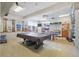 Engage in friendly competition in this recreation room featuring a pool table, ping pong, and a mini kitchen at 5246 81 N St # 24, St Petersburg, FL 33709