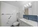 Bright bathroom featuring blue tiled accents, a vanity, and a toilet with shelving at 5428 Larchmont N Ct # 5428, Pinellas Park, FL 33782