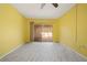 This bedroom features an exterior view to the outside patio and a ceiling fan at 5428 Larchmont N Ct # 5428, Pinellas Park, FL 33782