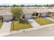 Street view of a home with a one car garage and neutral colored stucco at 5428 Larchmont N Ct # 5428, Pinellas Park, FL 33782