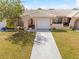 This home features a one car garage, a neutral colored exterior and well-manicured landscaping at 5428 Larchmont N Ct # 5428, Pinellas Park, FL 33782