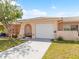 Charming single-story home featuring a well-manicured lawn and an attached garage at 5428 Larchmont N Ct # 5428, Pinellas Park, FL 33782