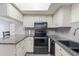 Stylish kitchen featuring stainless steel appliances, granite countertops, and ample cabinet space at 5428 Larchmont N Ct # 5428, Pinellas Park, FL 33782